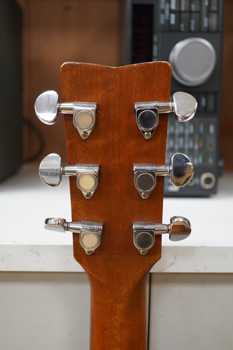 A Yamaha FG700MS acoustic guitar with a soft carry case